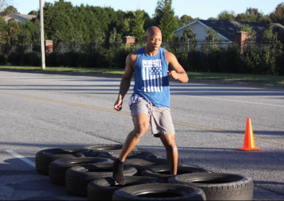 man running through tires